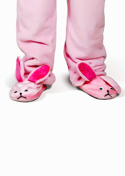 A person wears pink bunny pajama slippers with pajamas.