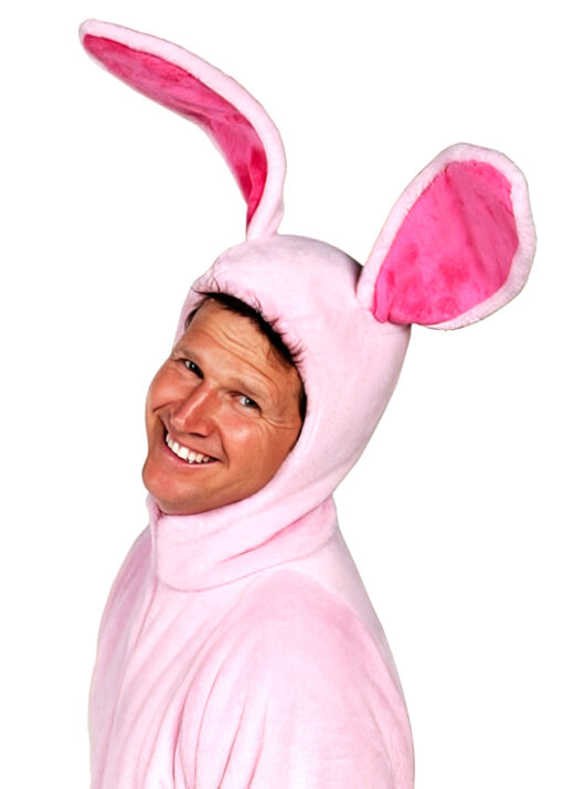 A man smiles as he wears his pink bunny pajamas