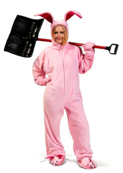 A woman holds a snow shovel while wearing pink bunny pajamas